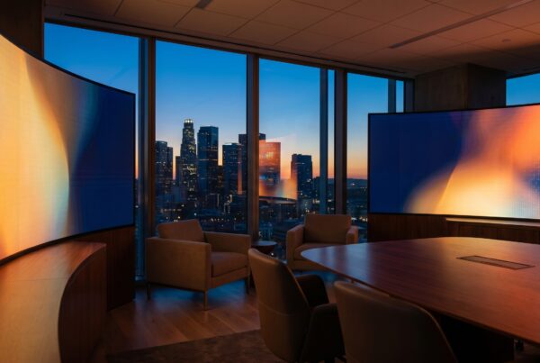 Modern strategy room with glowing screens showing a data-driven healthcare advertising channel mix at dusk.