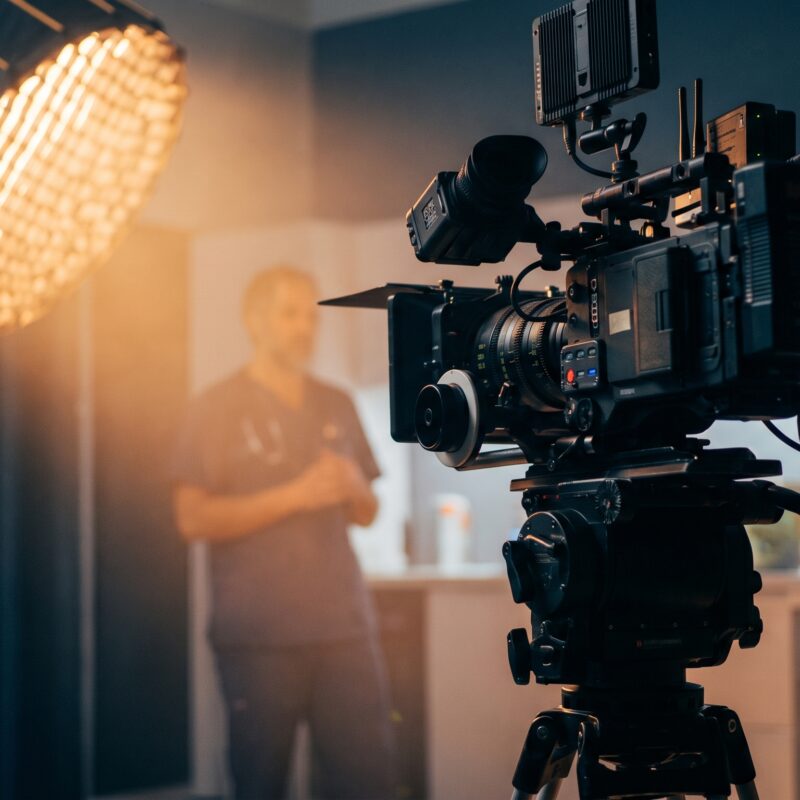 Clinician filmed on set with cinema camera and lights for healthcare video marketing and training.
