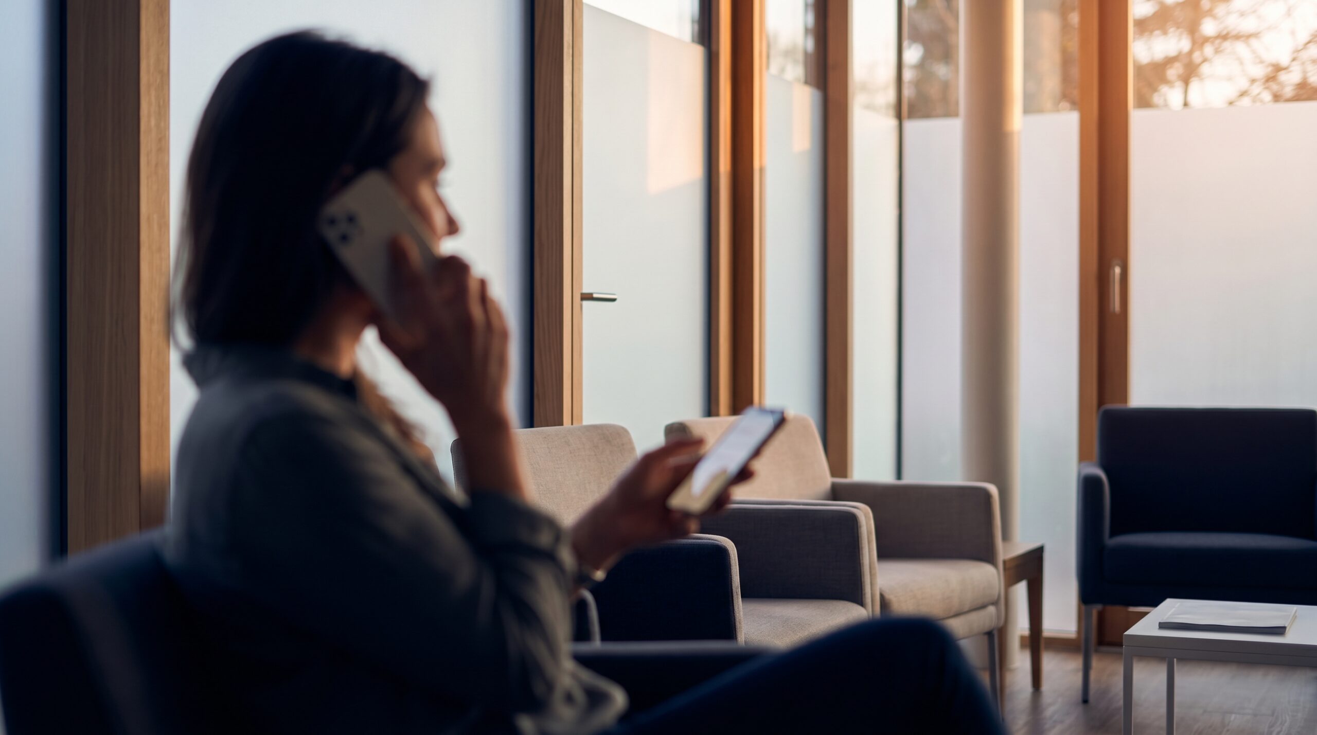 Patient in a modern clinic using a smartphone to experience the future of chatbots in healthcare.