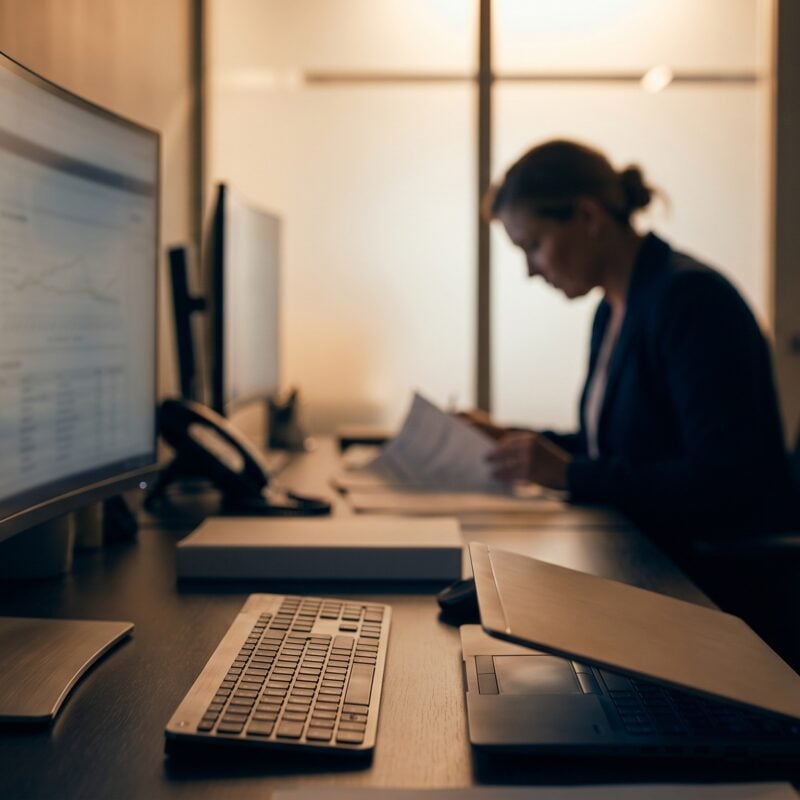 Clinician reviews data at a secure workstation using HIPAA-compliant AI in a clinic with warm lighting.