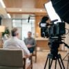 Professional cinema camera filming a clinician interview in a bright clinic for HIPAA compliant video marketing